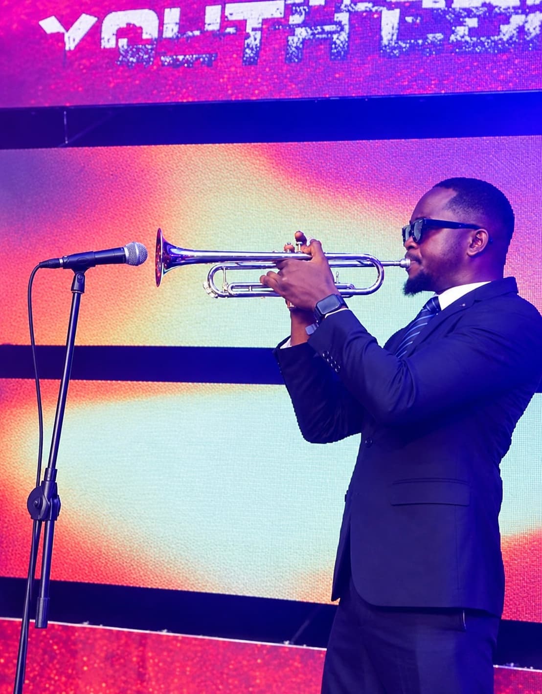 Oladimeji playing trumpet on stage